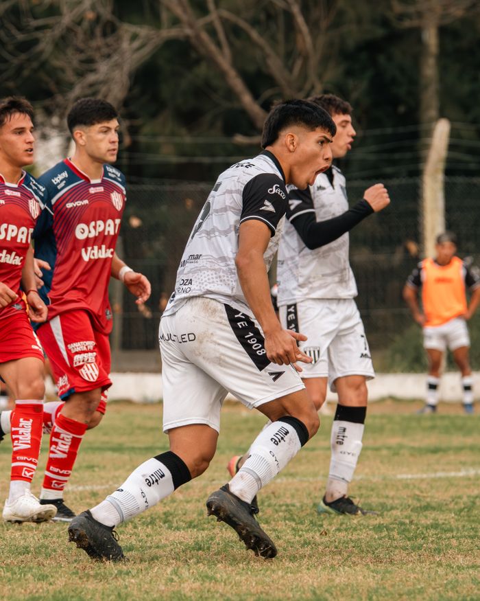 Dynamic action shot of young athletes competing fiercely on the soccer field.